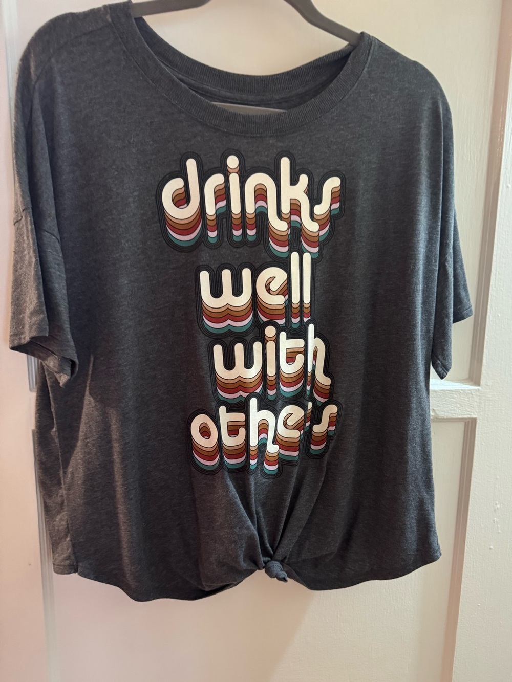 Graphic Tee with Retro Rainbow Text - Dark Gray says Drinks well with others